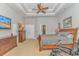 Main bedroom with tray ceiling, ceiling fan, television, and en-suite bathroom at 5303 Pheasant Dr., North Myrtle Beach, SC 29582