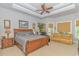 Bright main bedroom with tray ceiling, ceiling fan, sitting area, and natural light at 5303 Pheasant Dr., North Myrtle Beach, SC 29582