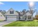 Charming single-Gathering home with blue siding, white trim, and a well-manicured front lawn at 639 Carter Reid Ct., Longs, SC 29568