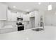 Modern kitchen with white cabinets, stainless steel appliances, and a spacious island at 639 Carter Reid Ct., Longs, SC 29568