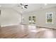 Bright living room with wood floors, vaulted ceiling, and sliding glass doors to the backyard at 639 Carter Reid Ct., Longs, SC 29568