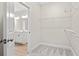 Walk-in closet with wire shelving and access to bathroom featuring a double vanity at 639 Carter Reid Ct., Longs, SC 29568