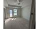 Spacious bedroom features tray ceiling, neutral walls, and door to outside at 780 Maxine Ct. # 8A, Myrtle Beach, SC 29577