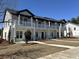 Elegant townhouses with front porches, white pillars, and manicured lawns at 780 Maxine Ct. # 8A, Myrtle Beach, SC 29577