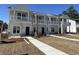 Newly built townhomes boasting covered porches, clean lines, and manicured lawns at 821 Rebecca Ln. # 6C, Myrtle Beach, SC 29577