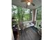 Relaxing screened porch with table and chairs, overlooking a wooded area at 1286 River Oak Dr. # 8-I, Myrtle Beach, SC 29579