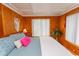 Bedroom with unique wood walls, bright windows, and stylish decor at 526 Dogwood Dr. N, Garden City Beach, SC 29576