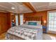Cozy bedroom featuring warm wood panelling, soft bedding, and ensuite bathroom at 526 Dogwood Dr. N, Garden City Beach, SC 29576