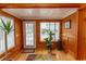 Charming entryway with wood paneling, light hardwood floors, and a colorful area rug at 526 Dogwood Dr. N, Garden City Beach, SC 29576
