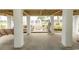 Spacious outdoor area featuring supporting pillars, a porch swing, and a view of the landscaped surroundings at 526 Dogwood Dr. N, Garden City Beach, SC 29576