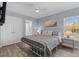 Cozy bedroom with a metal frame bed, ceiling fan, and natural light at 514 Vista Dr., Murrells Inlet, SC 29576