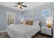 This bedroom features a ceiling fan, two windows for natural light and decoratively designed night stand at 514 Vista Dr., Murrells Inlet, SC 29576