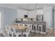 Kitchen with white cabinets, stainless steel appliances, barstool seating and wood table at 514 Vista Dr., Murrells Inlet, SC 29576