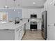 Modern kitchen featuring stainless steel appliances, white cabinets, and a sleek marble countertop at 514 Vista Dr., Murrells Inlet, SC 29576