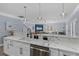 Open kitchen with waterfall marble countertops, stainless steel appliances, and views into living room at 514 Vista Dr., Murrells Inlet, SC 29576