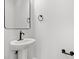 Classic pedestal sink, elegant mirror, and modern fixtures for a stylish and functional bathroom space at 132 Oak Bay Dr., Georgetown, SC 29440