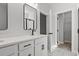 Bright bathroom with dual sinks, modern fixtures, and a walk-in closet, offering both style and storage at 132 Oak Bay Dr., Georgetown, SC 29440