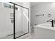 Modern bathroom features a glass enclosed shower with white tile and a sleek, dark framed shower door at 132 Oak Bay Dr., Georgetown, SC 29440