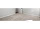 Neutral carpeted floor, white trim, and an open doorway create a clean and inviting bedroom space at 132 Oak Bay Dr., Georgetown, SC 29440