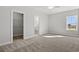 Bedroom with neutral carpet, walk-in closet, bathroom and window offer comfort and functionality at 132 Oak Bay Dr., Georgetown, SC 29440