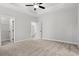 Spacious bedroom with a tray ceiling, plush carpet, ceiling fan, recessed lights, and closet doors at 132 Oak Bay Dr., Georgetown, SC 29440