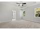 Spacious bedroom with a tray ceiling, fan, plush carpet, recessed lights, and an en-suite bathroom at 132 Oak Bay Dr., Georgetown, SC 29440
