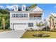 Charming two-story home featuring a covered porch, dormer windows, and a two-car garage with beautiful landscaping at 132 Oak Bay Dr., Georgetown, SC 29440