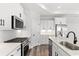 Well-appointed kitchen with white cabinets, stainless steel appliances, stone countertops, and modern fixtures at 132 Oak Bay Dr., Georgetown, SC 29440