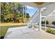 Covered patio featuring a concrete flooring leading to stairs and a serene backyard at 132 Oak Bay Dr., Georgetown, SC 29440