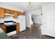Kitchen offers wood cabinets, electric stove, and views into the living room at 2201 John Henry Ln., Myrtle Beach, SC 29579