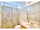 Bathroom featuring a toilet and a tub with a gold patterned shower curtain at 2513 Hunters Trail, Myrtle Beach, SC 29588
