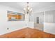 Open-concept dining room with hardwood floors, chandelier, and kitchen view at 2513 Hunters Trail, Myrtle Beach, SC 29588