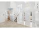 Bright foyer with a two-story ceiling, staircase, and tiled entry, leading to other rooms at 2513 Hunters Trail, Myrtle Beach, SC 29588