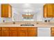 Close up of kitchen sink, wood cabinets, and view into another room at 2513 Hunters Trail, Myrtle Beach, SC 29588