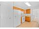 Bright kitchen with tan tile floor, wood cabinets, and white appliances at 2513 Hunters Trail, Myrtle Beach, SC 29588