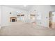 Large living room with a fireplace, carpeted flooring, high ceilings, and an open view to the dining area at 2513 Hunters Trail, Myrtle Beach, SC 29588