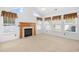 Cozy living room with a classic fireplace, carpeted flooring, and natural light streaming through multiple windows at 2513 Hunters Trail, Myrtle Beach, SC 29588