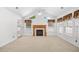 Bright, open living room with a fireplace, vaulted ceiling, multiple windows, and carpeted flooring at 2513 Hunters Trail, Myrtle Beach, SC 29588