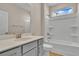 Modern bathroom with gray vanity, bathtub, and shower at 301 Broughton Dr., Myrtle Beach, SC 29579