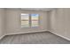 Cozy bedroom with neutral carpeting and two large windows at 301 Broughton Dr., Myrtle Beach, SC 29579