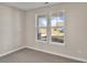 Bright bedroom with neutral walls, carpet flooring, and two windows at 301 Broughton Dr., Myrtle Beach, SC 29579