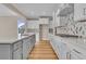 Modern kitchen with white cabinets, gray island, and quartz countertops at 301 Broughton Dr., Myrtle Beach, SC 29579