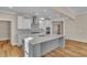 Modern kitchen with white cabinets, gray island, and quartz countertops at 301 Broughton Dr., Myrtle Beach, SC 29579
