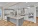 Modern kitchen with white cabinets, gray island, stainless steel appliances, and quartz countertops at 301 Broughton Dr., Myrtle Beach, SC 29579