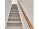 Modern carpeted staircase with a simple wooden handrail at 301 Broughton Dr., Myrtle Beach, SC 29579