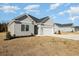 Gray siding, white trim, and a two-car garage in a new home development at 369 Log Cabin Rd., Loris, SC 29569