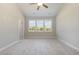 Bright bedroom with three windows, ceiling fan, and carpet at 381 Log Cabin Rd., Loris, SC 29569