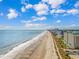 Expansive aerial beach view of the sandy coastline, city buildings, and calm blue waters at 1605 S Ocean Blvd. # 410, Myrtle Beach, SC 29577