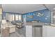 Comfortable living room with blue accent wall, stylish furniture, and sliding door access to the outside at 1605 S Ocean Blvd. # 410, Myrtle Beach, SC 29577
