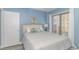 Serene main bedroom featuring balcony access, blue accents, and comfortable king size bed at 1605 S Ocean Blvd. # 410, Myrtle Beach, SC 29577